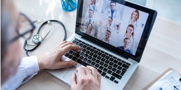 male doctor having video conference on laptop with his colleagues at picture id