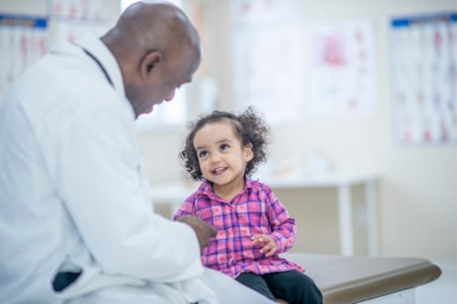 Pediatrician talking with his patient