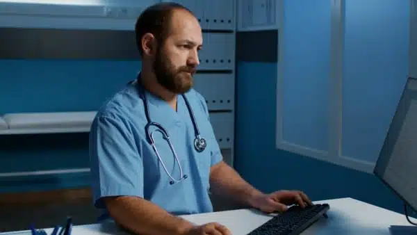 Doctor reviewing medical information on his computer